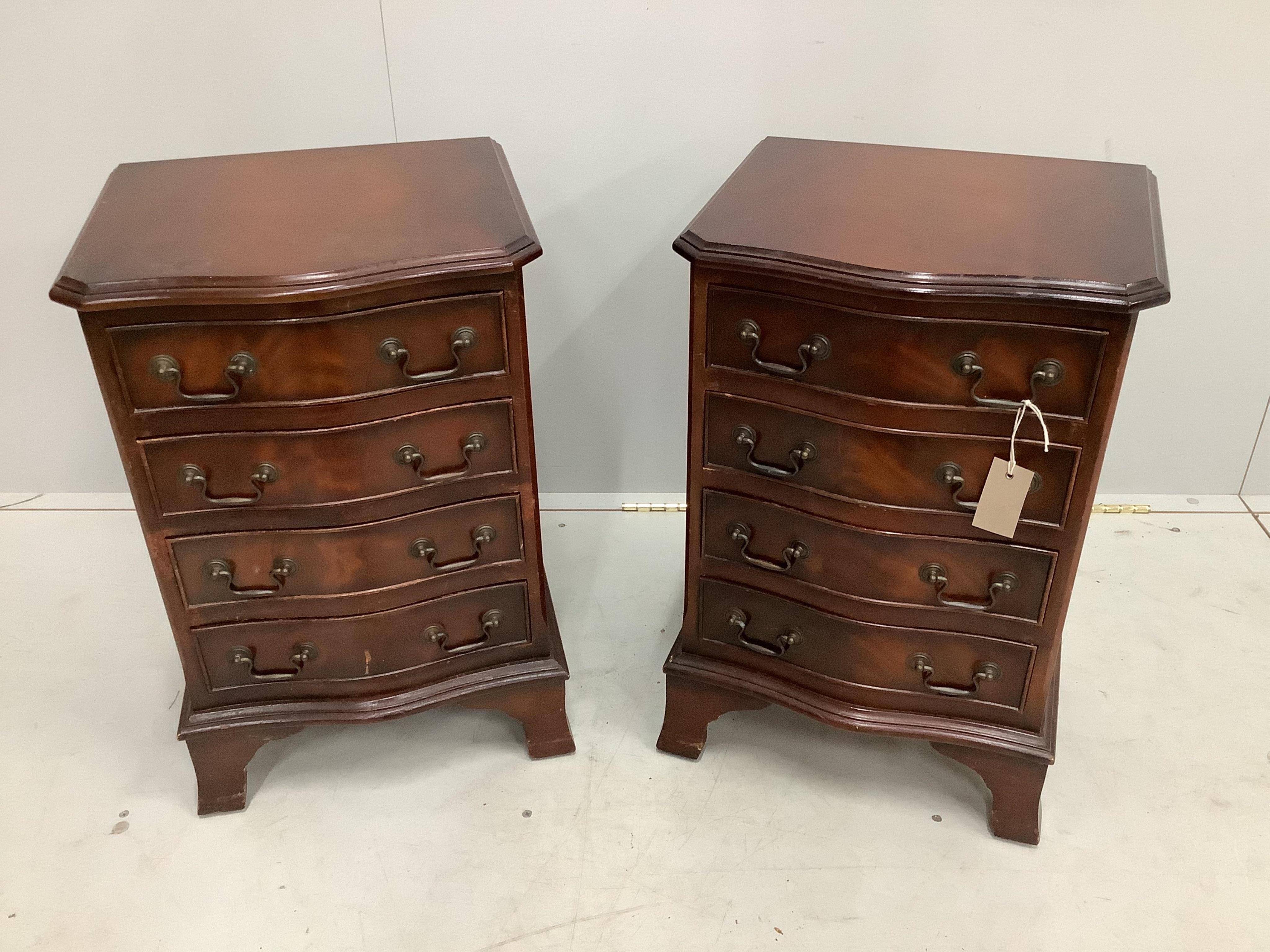 A pair of reproduction four drawer mahogany serpentine bedside chests, width 40cm, depth 35cm, height 61cm